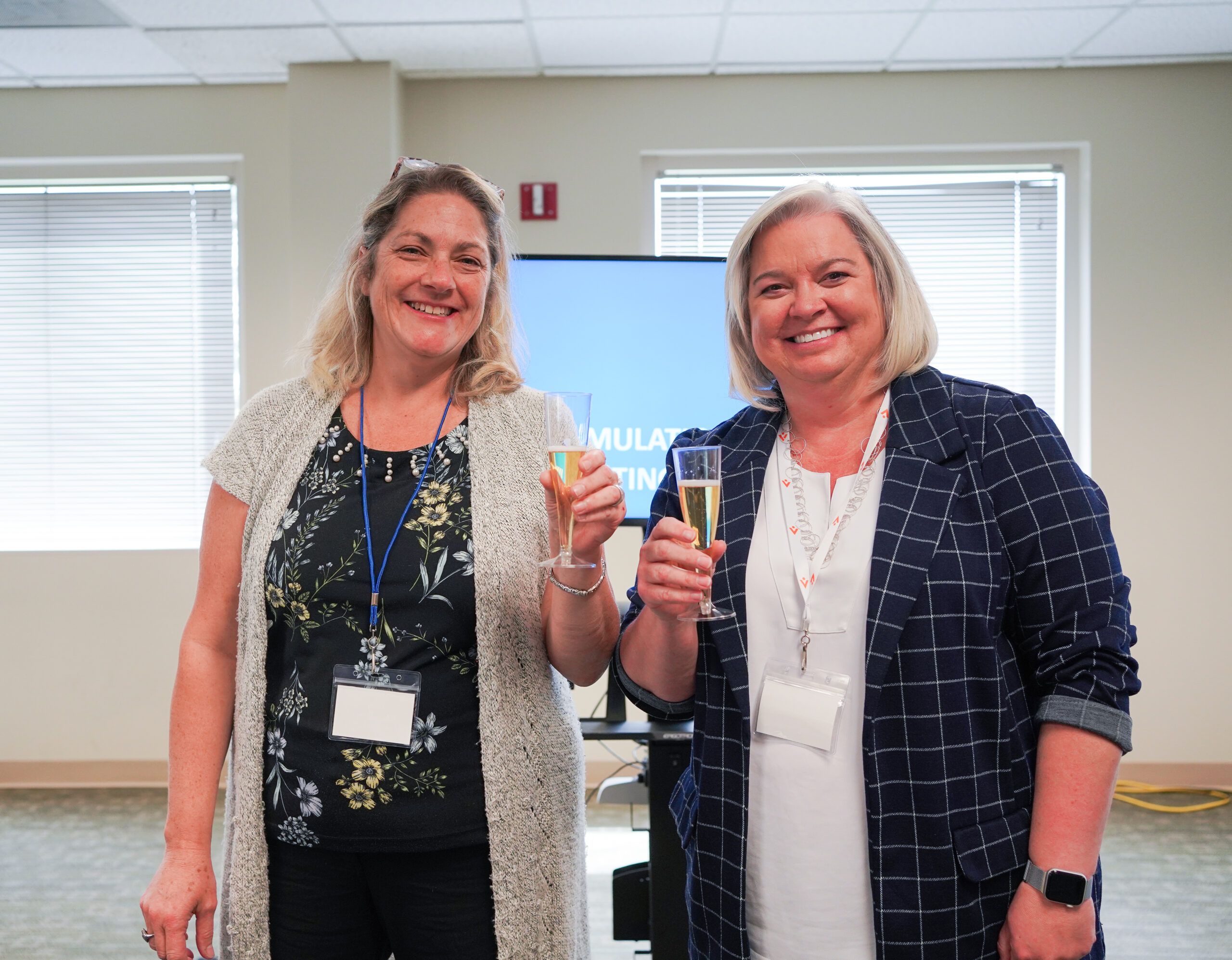 Avkin CEO, Amy Cowperthwait and Crystel Farina,Director of Simulation and Experiential Learning at GWU toast apple cider at SIM Summit George Washington University
