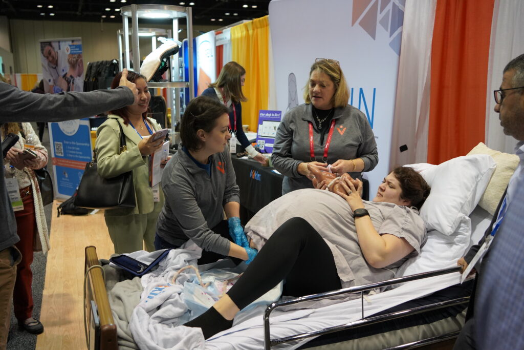 Avbirth birthing simulator in the middle of being demoed at IMSH 2023 with Avkin Standardized Patient